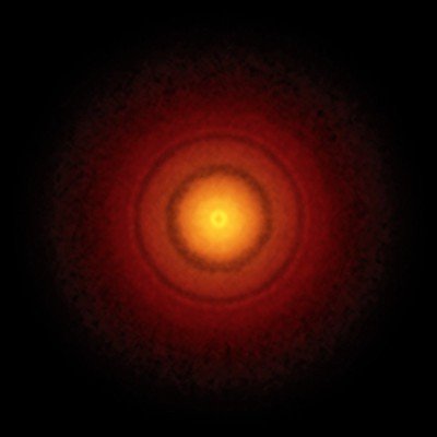 Cavidade na poeira de um disco protoplanetário, causada por algum objeto grande, captada pelo telescópio ALMA.
